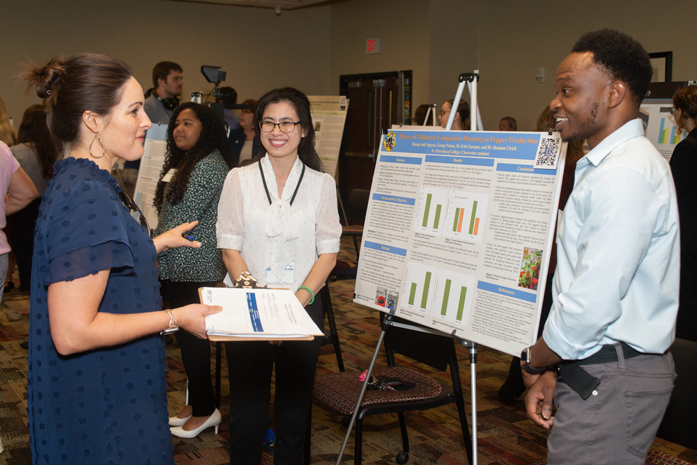 two students and reviewers discussing a presentation