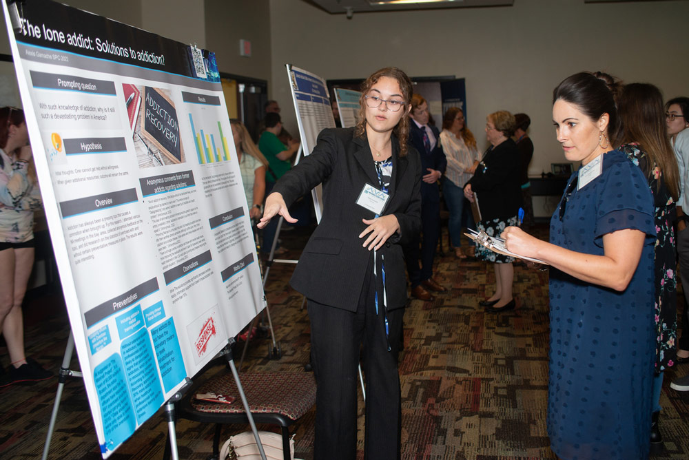 students and reviewers discussing a presentation